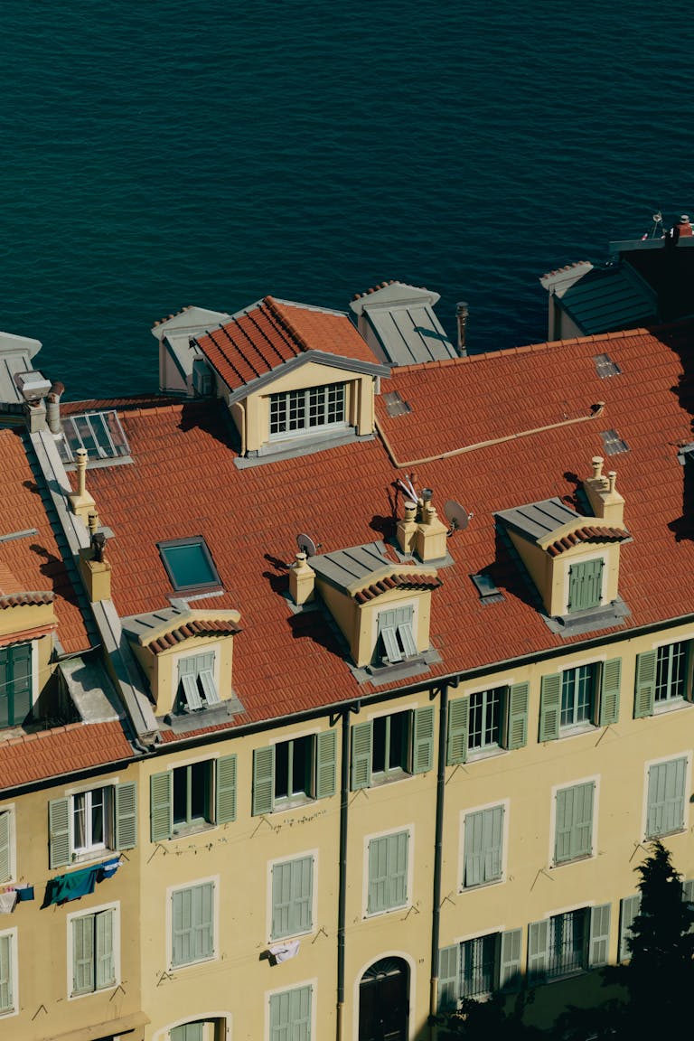 Charming historic buildings with terra-cotta roofs overlooking the Mediterranean in Nice, France.